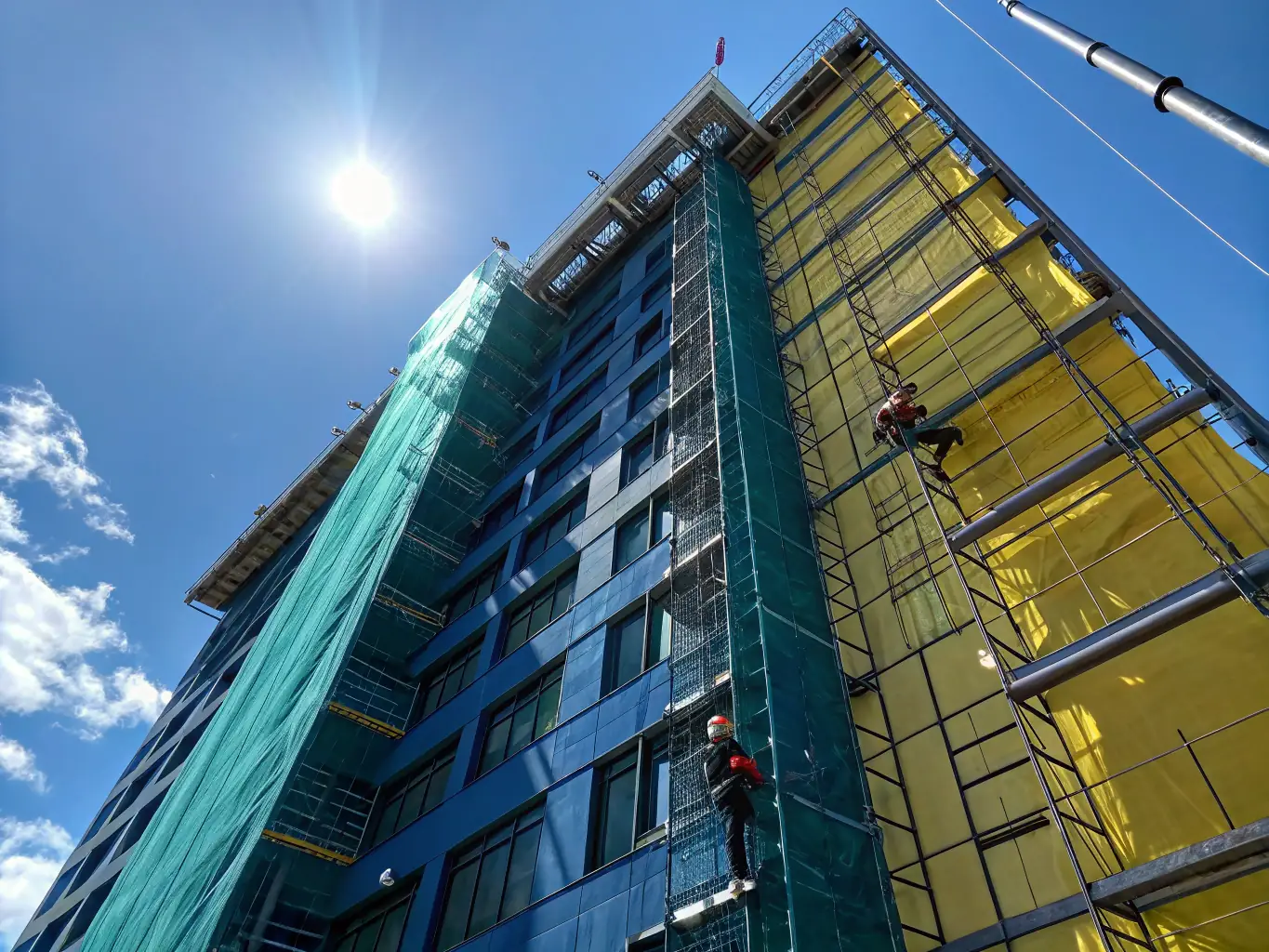 A high-rise building with workers applying waterproofing to the rooftop and external facade. The image should convey the specialized skills and equipment required for high-rise projects.